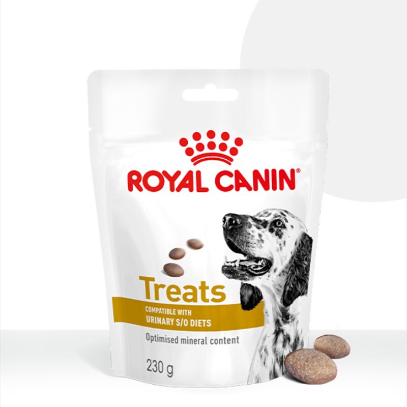 De verpakking van Royal Canin Treats voor Urinary S/O diets, met enkele snoepjes in de voorgrond.